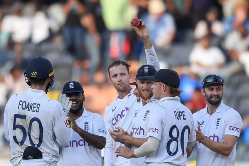 Tom Hartley (C) claimed seven wickets in India's second innings to help England to victory in the first Test in Hyderabad