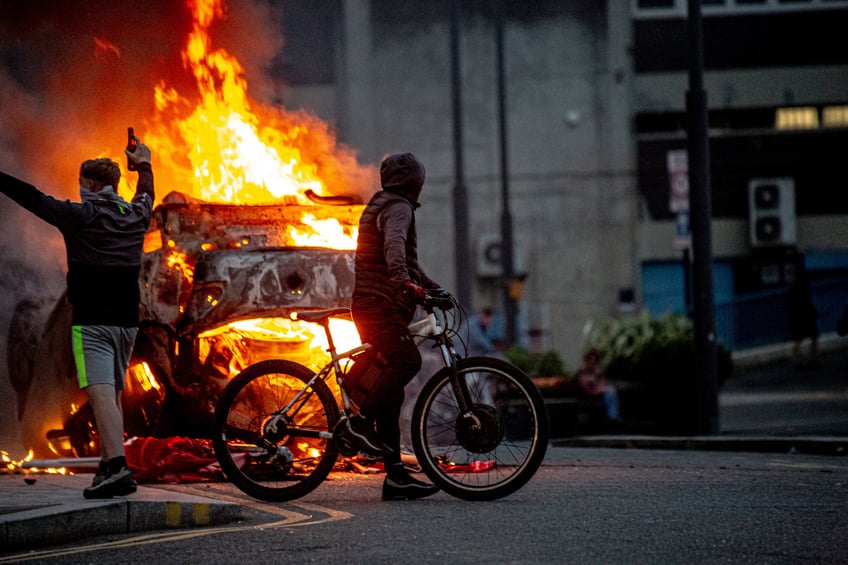 SUNDERLAND, ENGLAND - AUGUST 02: A police car is set on fire as Far-right activists hold an 'Enough is Enough' protest on August 02, 2024 in Sunderland, England. After the murders of three girls in Southport earlier this week, misinformation spread via social media and fueled acts of violent rioting from far-right actors across England. While they prefer to be called 'concerned parents', their actions point to racial hatred with a particular focus on Islamophobia thus targeting mosques. (Photo by Drik/Getty Images)