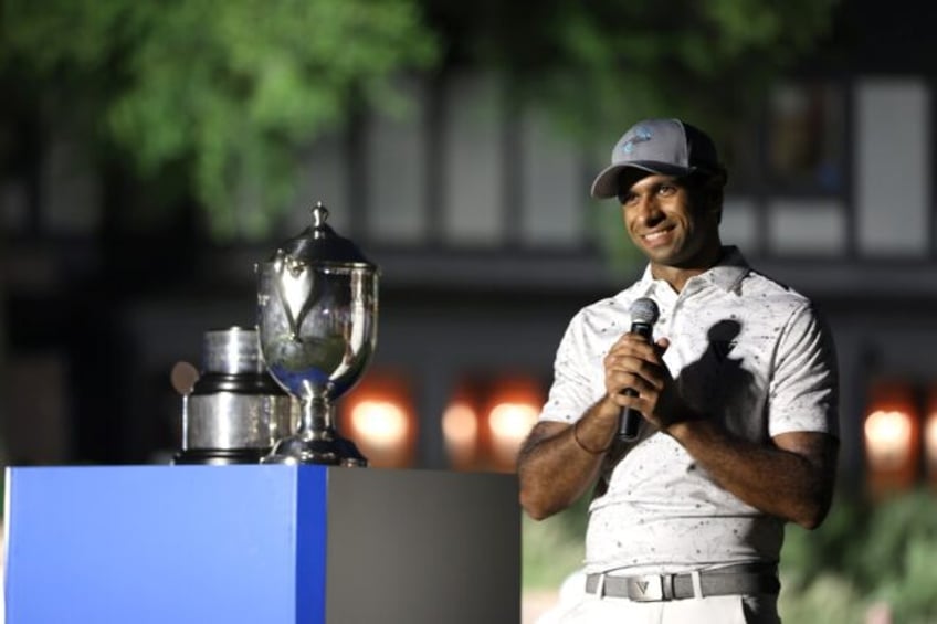 Aaron Rai of England accepts the trophy after winning his first PGA Tour title at the Wynd