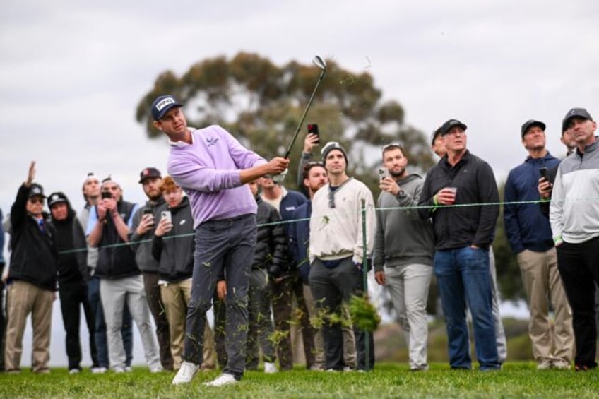 Harris English hits his approach at the 18th hole on the way to victory in the US PGA Tour