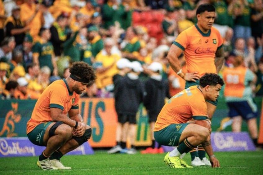 (From left) Rob Valetini, Hunter Paisami and Len Ikitau look dejected following Australia'