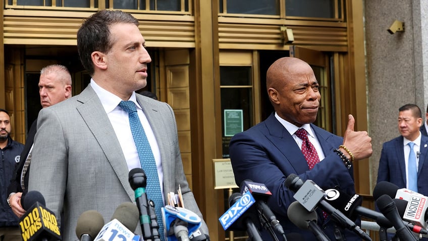 New York City Mayor Eric Adams gestures next to lawyer Alex Spiro