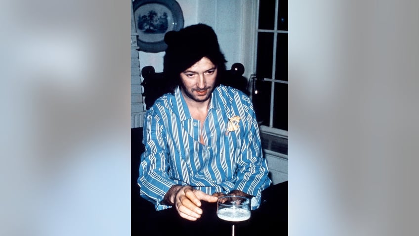 Eric Clapton about to grab a glass of beer