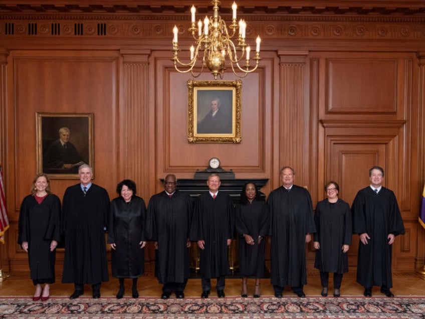 In this image provided by the Supreme Court, members of the Supreme Court pose for a photo