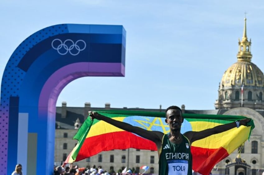 Ethiopia's Tamirat Tola celebrates after winning the men's marathon at the Paris Olympics