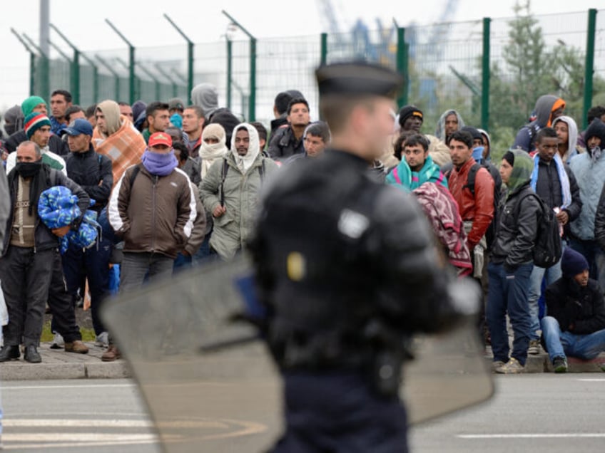 TOPSHOT - Illegal immigrants wait to be expelled from their camp at Calais on May 28, 2014. French police early Wednesday began expelling around 650 migrants from camps in the northern port of Calais. AFP PHOTO / DENIS CHARLET (Photo by DENIS CHARLET / AFP) (Photo by DENIS CHARLET/AFP via …