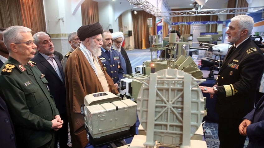 Ayatollah Khameni looks on to a defense demonstration 