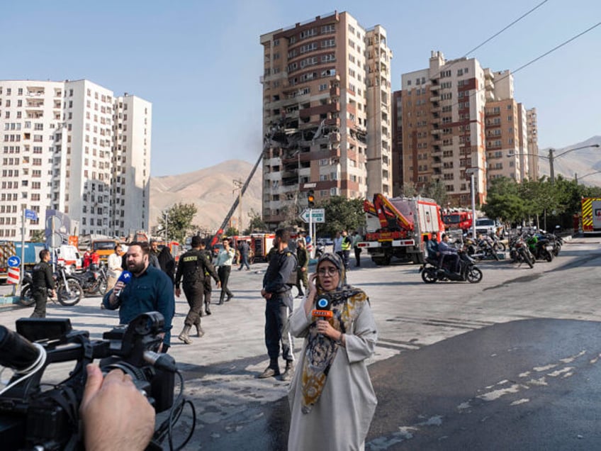 Iranian reporters report from the scene of an explosion at a residential complex due to Is