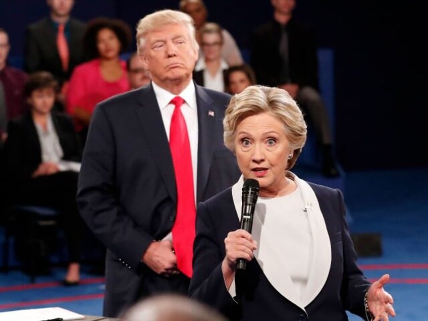 FILE - In this Oct. 9, 2016 file photo, Democratic presidential nominee Hillary Clinton, right, speaks as Republican presidential nominee Donald Trump listens during the second presidential debate at Washington University in St. Louis, Sunday, Oct. 9, 2016. (Rick T. Wilking/Pool via AP)