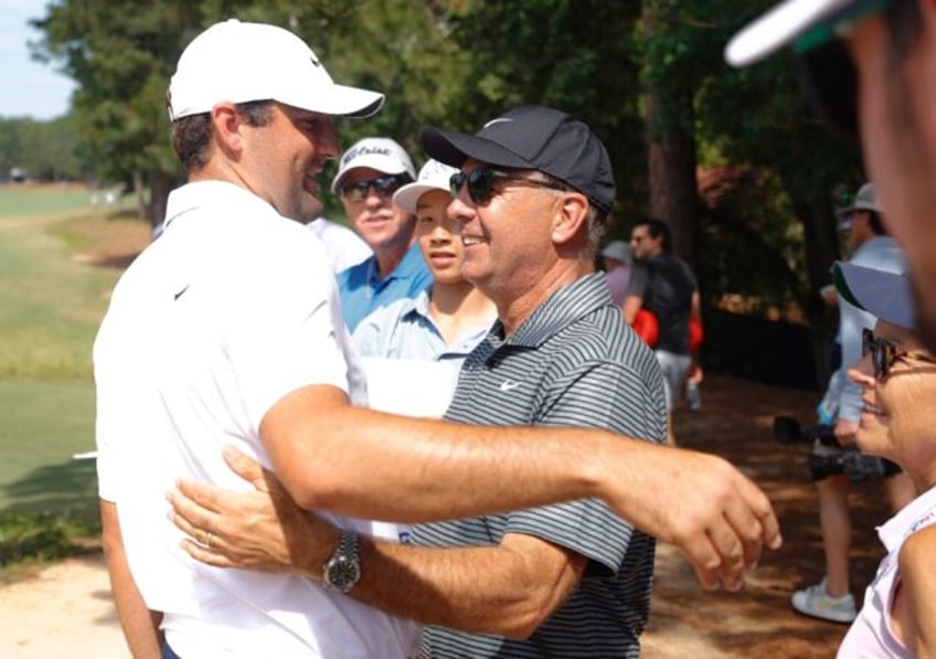 Top-ranked Scottie Scheffler, left, shares a hug with his father, Scott Scheffler, during