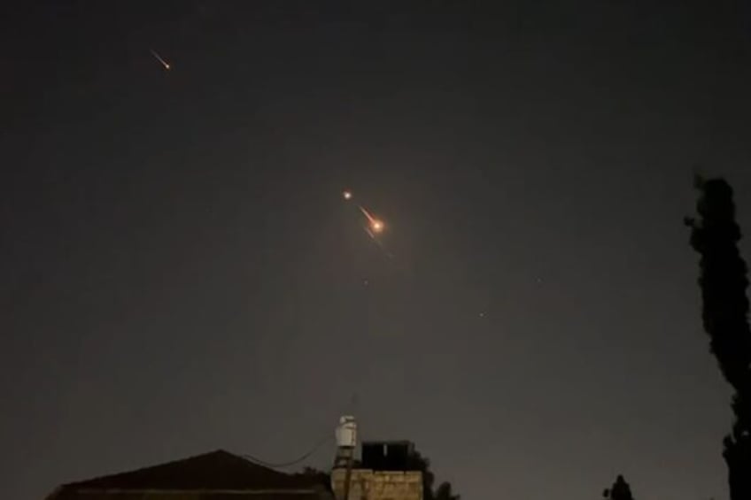 Explosions light up the sky over Jerusalem as Israeli air defences intercept incoming Iran