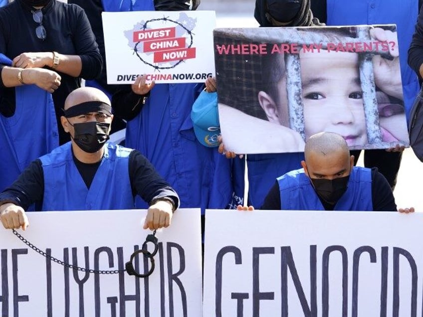 Members of the Uyghur American Association rally in front of the White House, Thursday, Oc