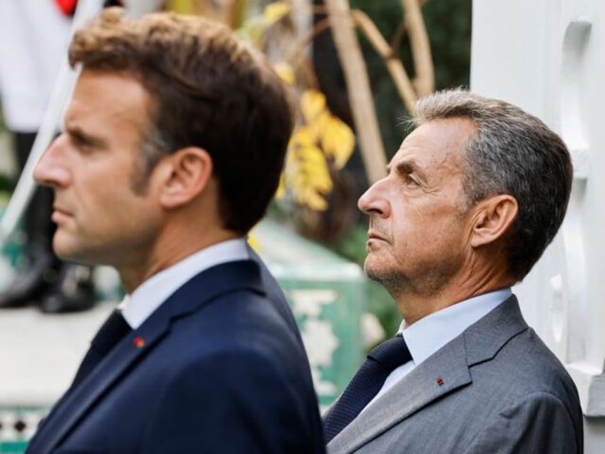 French President Emmanuel Macron (L) looks on next to former French President Nicolas Sark