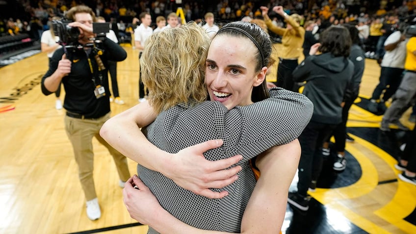 Iowa guard Caitlin Clark gets a hug from head coach Lisa Bluder after a game against Michigan on Feb. 27, 2022, in Iowa City.