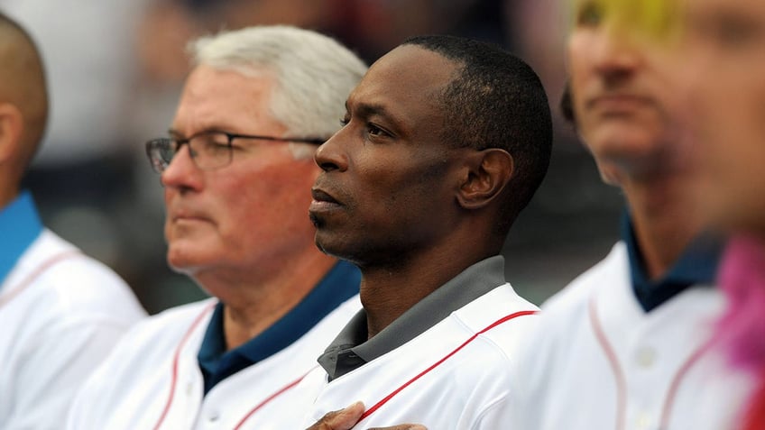 Kenny Lofton looks on during national nathem