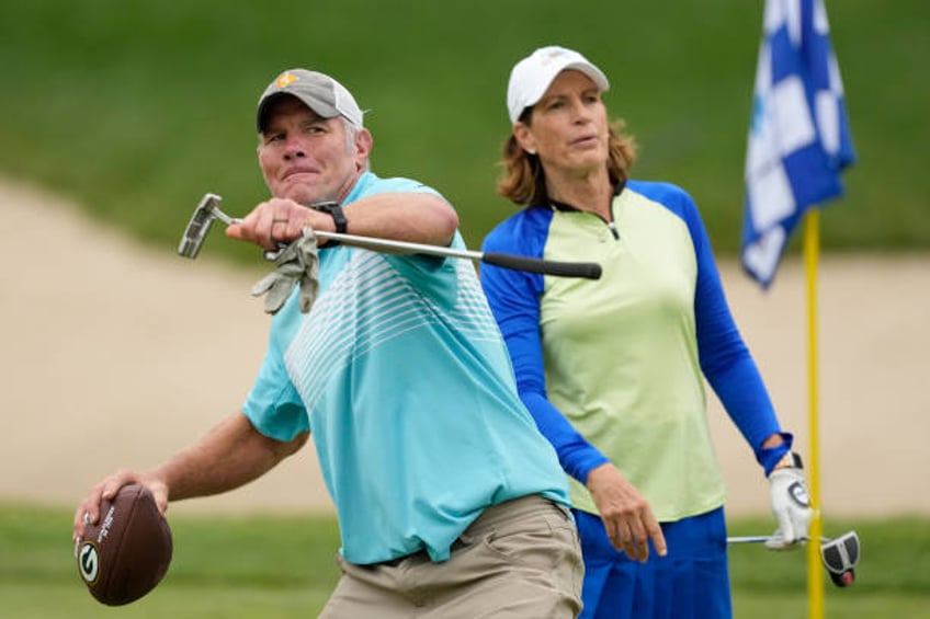 Former NFL player Brett Favre throws a football to a fan on the 14th green during the Celebrity Foursome at the second round of the American Family...