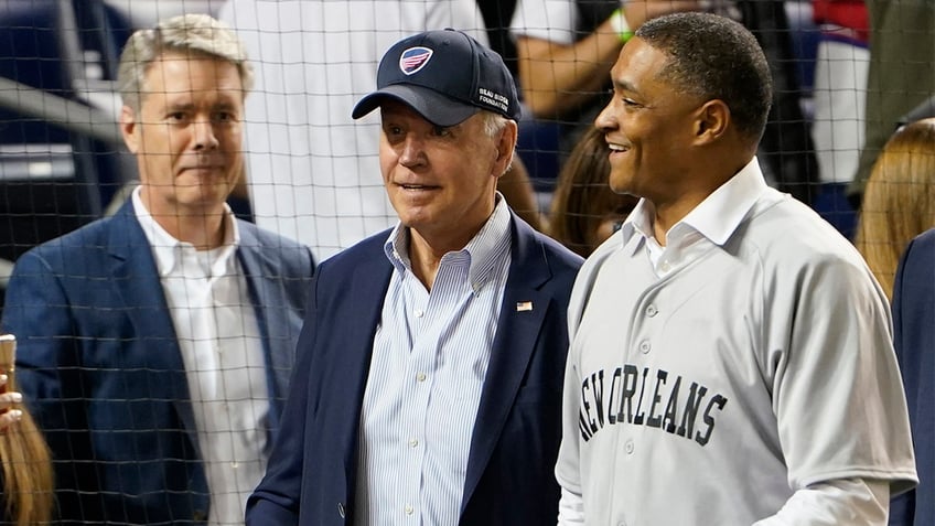 President Biden walks on the field with White House senior adviser Cedric Richmond as he attends the Congressional baseball game at Nationals Park Wednesday, Sept. 29, 2021, in Washington.