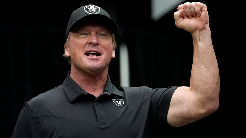 Jon Gruden raises his fist