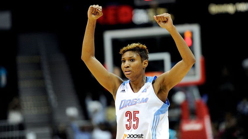 Angel McCoughtry with her arms raised