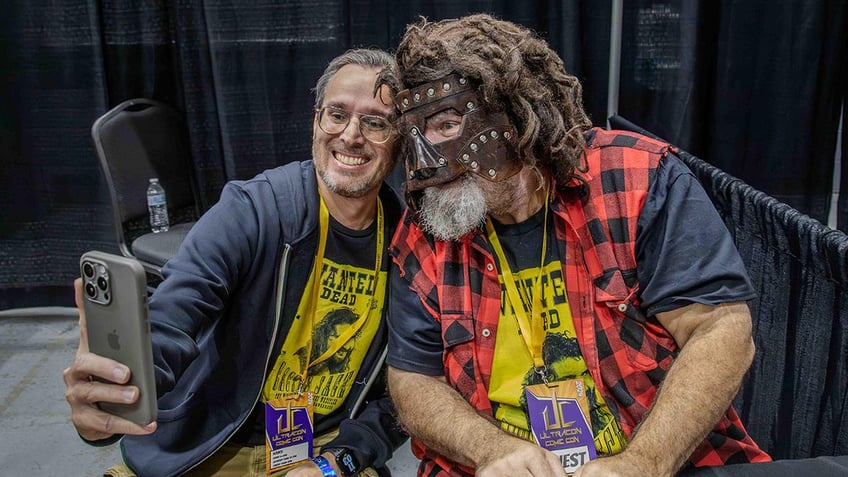 Mick Foley poses with fan