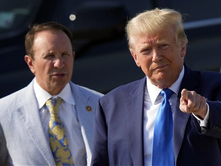 Former President Donald Trump arrives at New Orleans International Airport in New Orleans, Tuesday, July 25, 2023, accompanied by Louisiana Attorney General Jeff Landry, left. (AP Photo/Gerald Herbert)