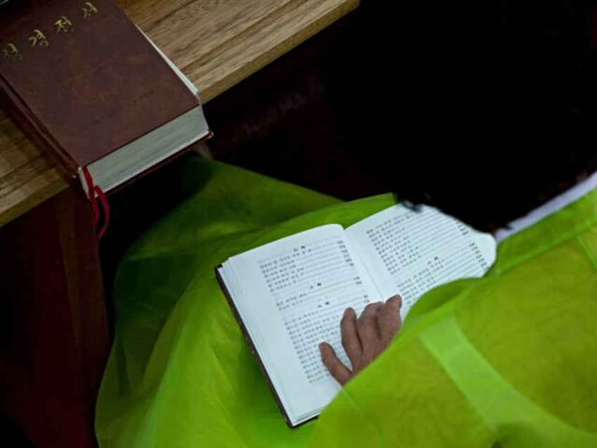 PYONGYANG, NORTH KOREA - SEPTEMBER 07: North Korean worshiper reading the bible during a sunday mass in protestant Bongsu church, Pyongan Province, Pyongyang, North Korea on September 7, 2008 in Pyongyang, North Korea. (Photo by Eric Lafforgue/Art In All Of Us/Corbis via Getty Images)