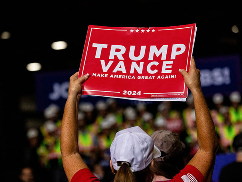 An attendee holds a sign as during a campaign event with former US President Donald Trump,