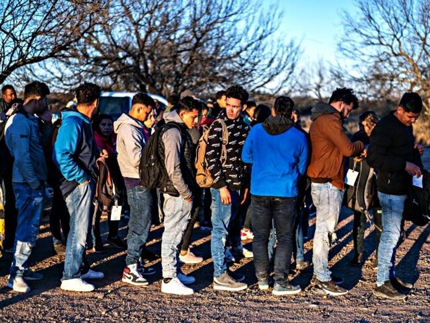 A group of migrants are processed by Border Patrol after crossing the river illegally near the highway on February 4, 2024 outside Eagle Pass, Texas. Eagle Pass, about 20 miles (30 kilometers) from Quemado, has become the epicenter of a prickly conflict between Texas Governor Greg Abbott, a Republican, and …