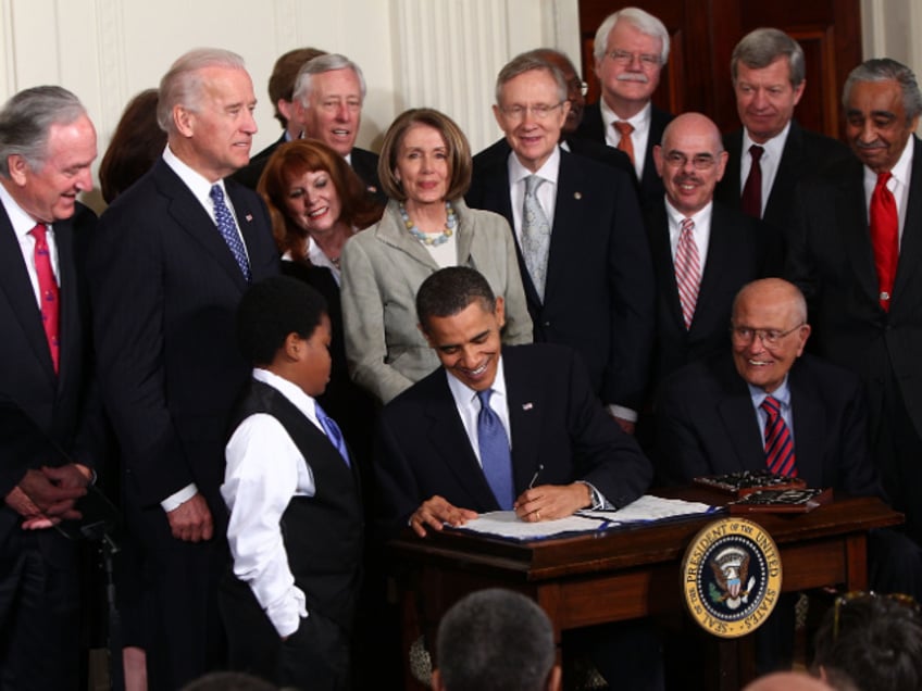 WASHINGTON - MARCH 23: U.S. President Barack Obama signs the Affordable Health Care for America Act during a ceremony with fellow Democrats in the East Room of the White House March 23, 2010 in Washington, DC. The historic bill was passed by the House of Representatives Sunday after a 14-month-long political battle that left the legislation without a single Republican vote. (Photo by Win McNamee/Getty Images)