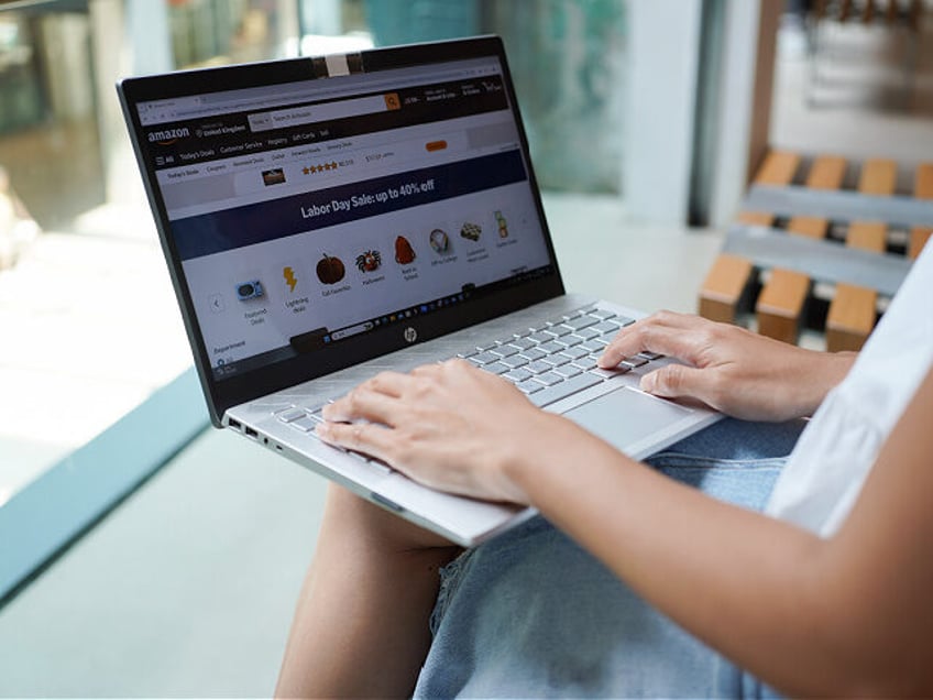 CHINA - 2024/09/29: In this photo illustration, a woman browses the Amazon website on her