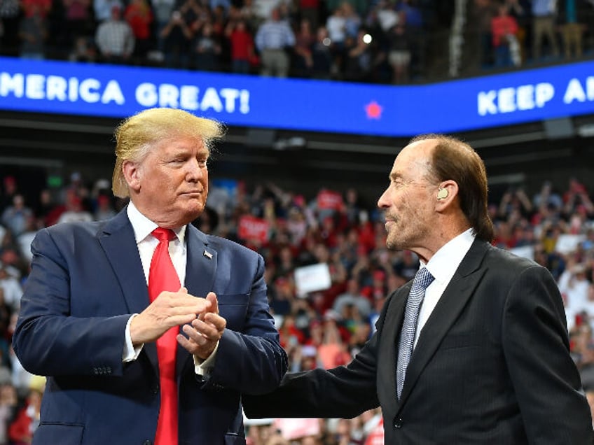US President Donald Trump (L) stands with US singer Lee Greenwood during a rally at Rupp A