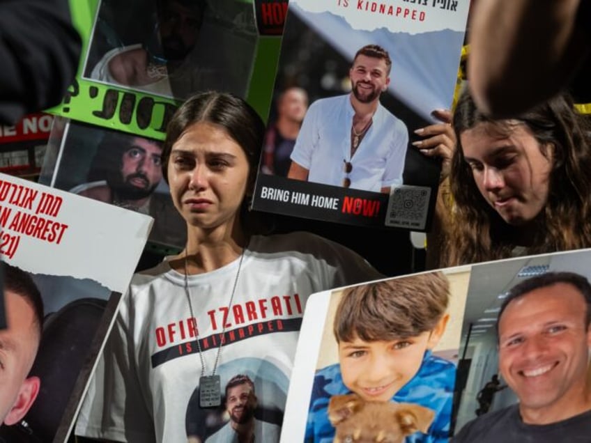 TEL AVIV, ISRAEL - NOVEMBER 18: Families of hostages react during a rally to demand that Israeli Prime Minister Benjamin Netanyahu secures the release of Israeli hostages following a march to Jerusalem by thousands of demonstrators, outside The Museum of Modern Art known as the 'The Hostages and Missing Square' …