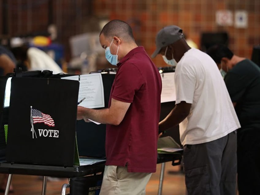 MIAMI, FLORIDA - OCTOBER 19: Voters fill out their ballots as they vote at the Stephen P.