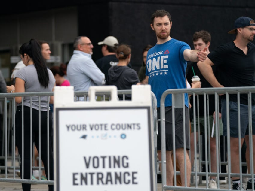 CHARLOTTE, NC - NOVEMBER 05: People wait in line on the final day of early voting at a pol