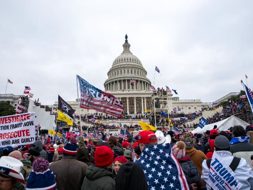 FILE - In this Jan. 6, 2021, file photo insurrections loyal to President Donald Trump rally at the U.S. Capitol in Washington. U.S. Capitol Police officers who were attacked and beaten during the Capitol riot filed a lawsuit Thursday, Aug. 26, against former President Donald Trump, his allies and members of far-right extremist groups, accusing them of intentionally sending insurrectionists to disrupt the congressional certification of the election in January. (AP Photo/Jose Luis Magana, File)