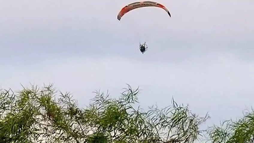 A suspected Hamas terrorist flying over Gaza as part of the terror group's specialized unit.