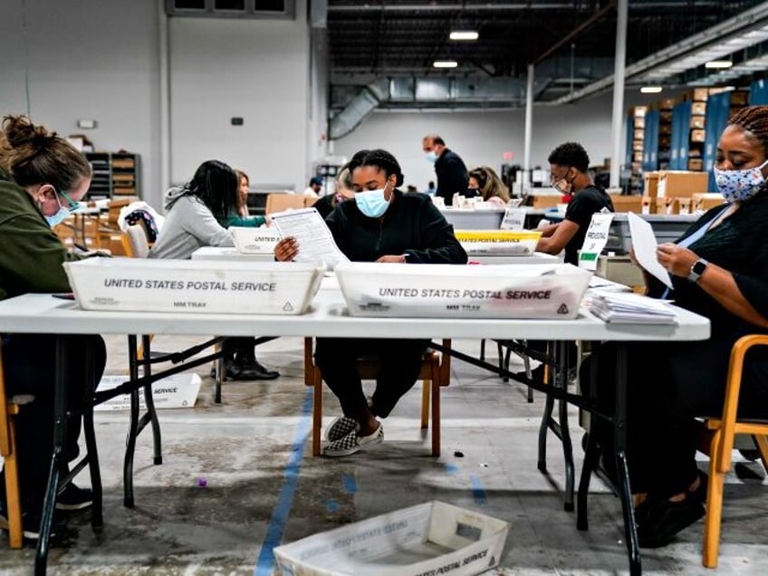 LAWRENCEVILLE, GA - NOVEMBER 06: Election workers validate ballots at the Gwinnete County Elections Office on Friday, Nov. 6, 2020 in Lawrenceville, GA. With the surge in vote by mail/absentee ballots, analysts cautioned it could take days to count all the ballots, leading some states to initially look like victories …