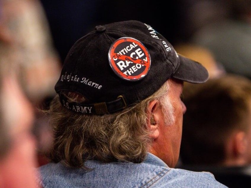 An audience member wears an anti-critical race theory hat as Florida governor Ron DeSantis