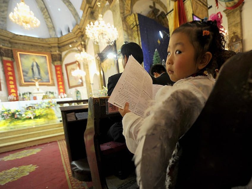 A young girl dressed as an angel attends the Christmas Eve mass at a Catholic church in Beijing on December 24, 2010. The Vatican and China have not had formal diplomatic ties since 1951, when the Holy See angered Mao Zedong's Communist government by recognising the Nationalist Chinese regime as the legitimate government of China. AFP PHOTO/LIU JIN (Photo credit should read LIU JIN/AFP/Getty Images)