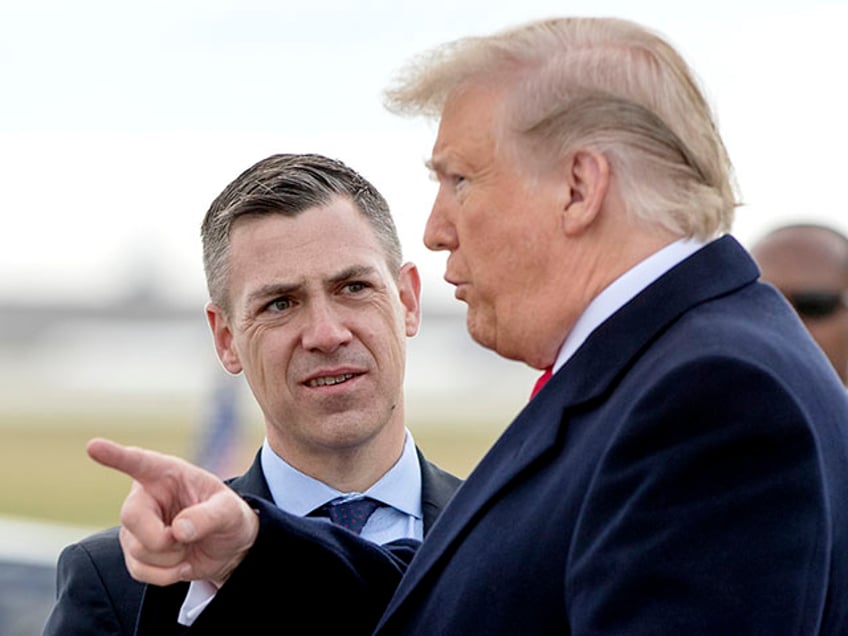 FILE - In this Oct. 27, 2018 file photo, President Donald Trump is greeted by Rep. Jim Banks, R-Ind., as he arrives at Indianapolis International Airport in Indianapolis. House Speaker Nancy Pelosi is rejecting two Republicans tapped by House GOP Leader Kevin McCarthy to sit on a committee investigating the Jan. 6 Capitol insurrection. She cited the “integrity” of the investigation. Pelosi said in a statement Wednesday that she would not accept the appointments of Indiana Rep. Jim Banks, whom McCarthy picked to be the top Republican on the panel, or Ohio Rep. Jim Jordan. Both are close allies of former President Donald Trump. (AP Photo/Andrew Harnik)