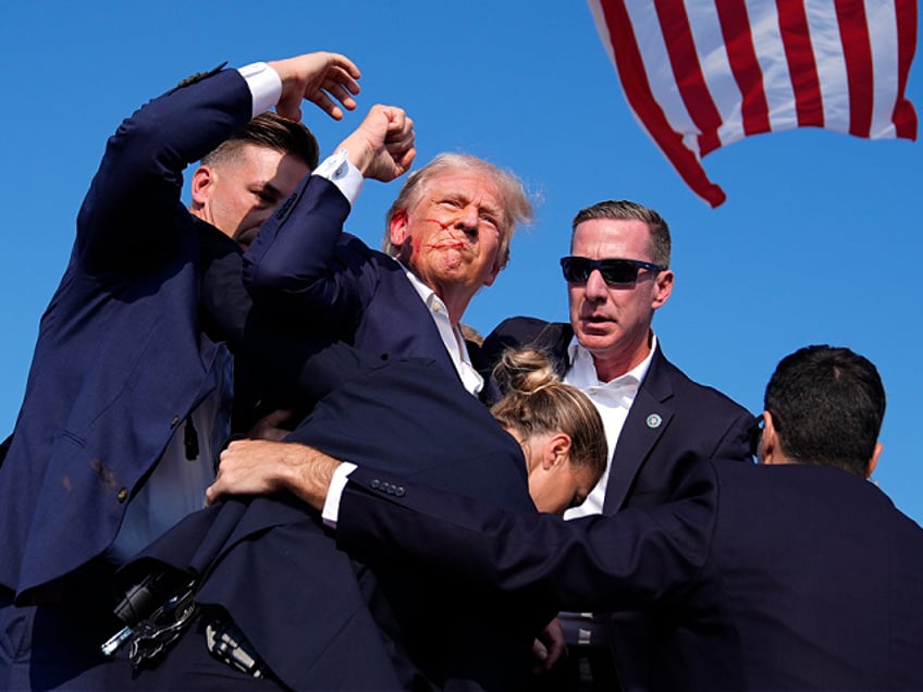 FILE - Republican presidential candidate former President Donald Trump is surround by U.S. Secret Service agents at a campaign rally, Saturday, July 13, 2024, in Butler, Pa. (AP Photo/Evan Vucci, File)