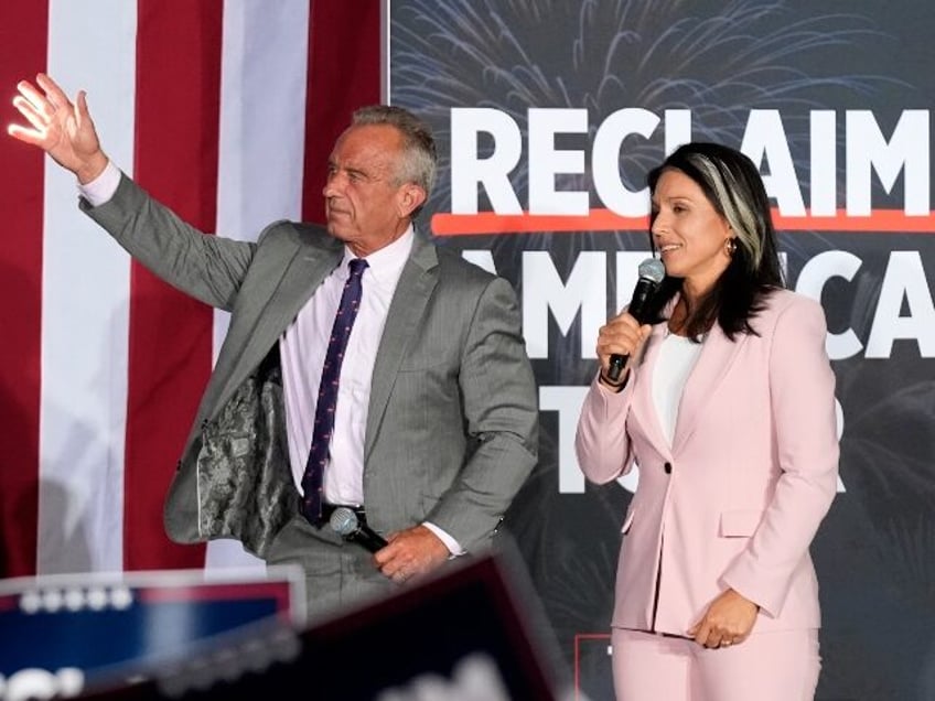 Former Independent candidate for president Robert F. Kennedy, Jr., left, waves to the crow