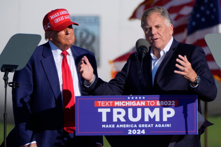 Republican presidential candidate former President Donald Trump listens as Michigan Senate