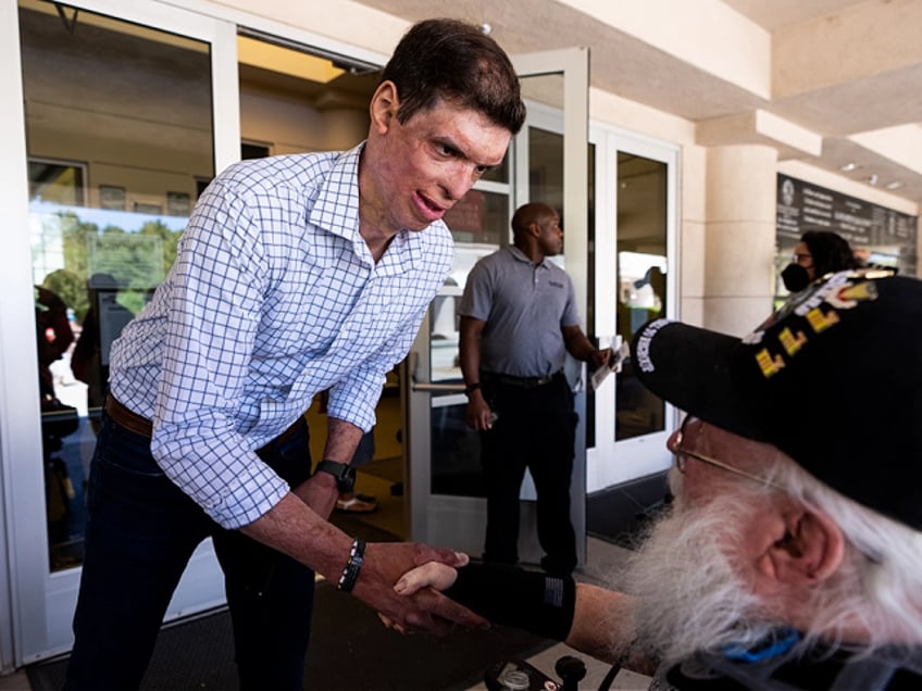 UNITED STATES - MAY 30: Nevada Republican candidate for U.S. Senate Sam Brown shakes hands with a veteran at the Memorial Day Ceremony at the Southern Nevada Veterans Memorial Cemetery in Boulder City, Nev., on Monday, May 30, 2022. (Bill Clark/CQ-Roll Call, Inc via Getty Images)