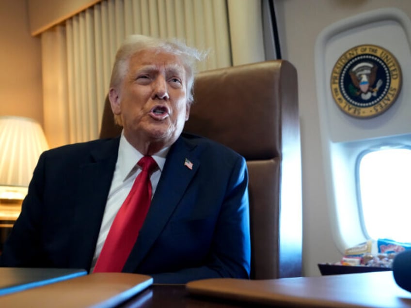 President Donald Trump speaks to reporters aboard Air Force One where Trump signed a procl