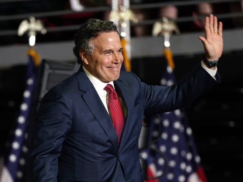 Republican Senate candidate Dave McCormick walks on stage to speak at a campaign rally for