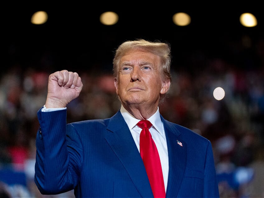 Republican presidential nominee former President Donald Trump pumps his fist as he arrives