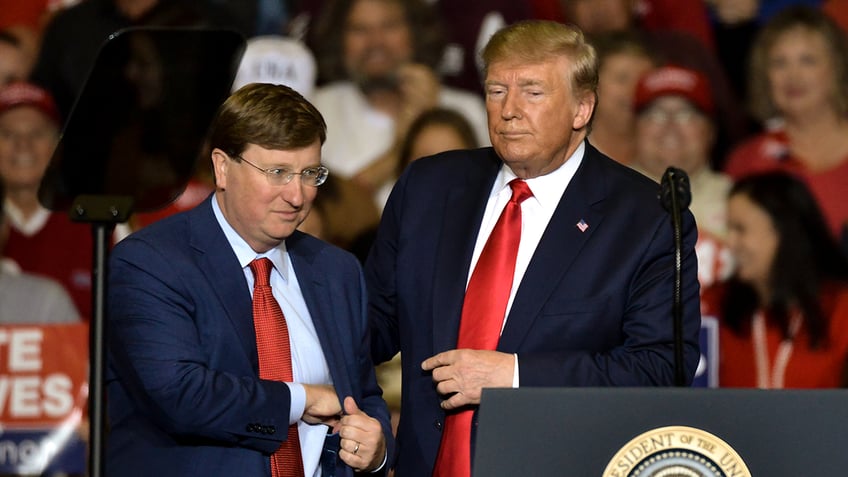 Mississippi Republican gubernatorial candidate Tate Reeves, left, stands with President Donald Trump during a "Keep America Great" campaign rally at BancorpSouth Arena on November 1, 2019 in Tupelo, Mississippi.