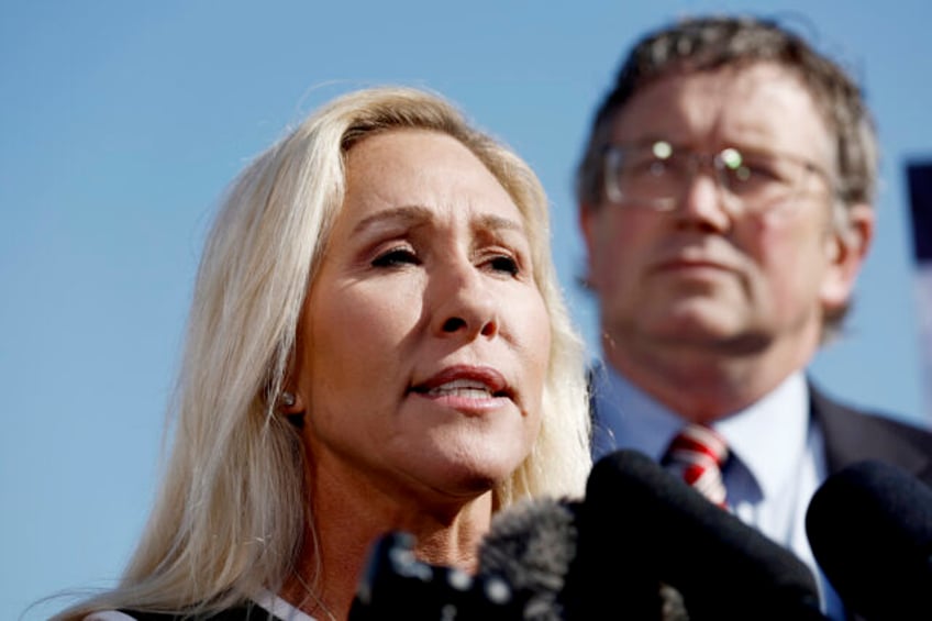 Rep. Marjorie Taylor Greene (R-GA) speaks at a news conference alongside Rep. Thomas Massi