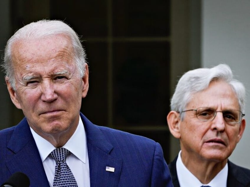 WASHINGTON, DC - MAY 13: Attorney General Merrick Garland looks on as U.S. President Joe B